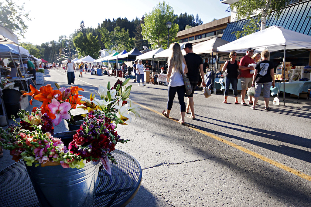 A photo of a few people walking through the Farmers Market in Kimberley BC