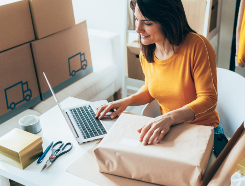 Woman preparing package for shipping